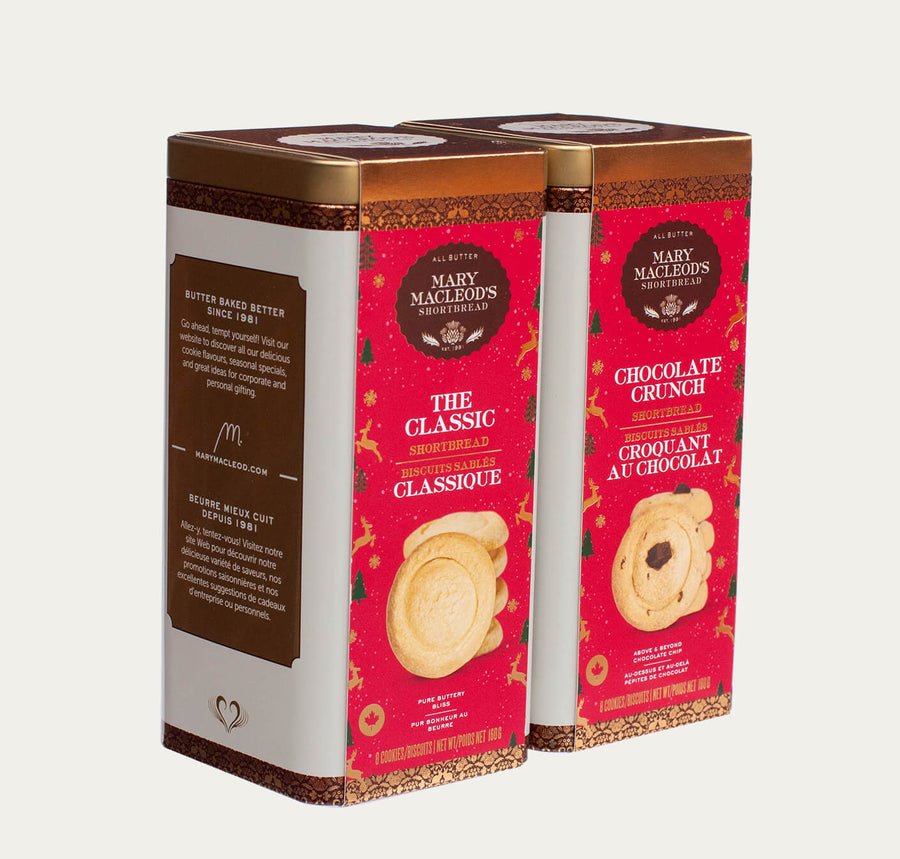 Angled image view of mary macleod's shortbread Festive red tin canister with gold foil accents, filled with 8 handcrafted all-butter classic shortbread cookies, ideal for Christmas gifting and holiday celebrations. This image contains two (2) Christmas Tin canisters side-by-side.