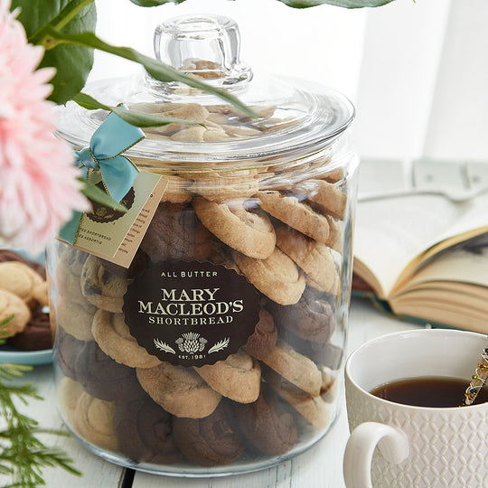 One 4 Quart Cookie jar of assorted artisan shortbread cookies by mary macleods shortbread beside a cup of coffee