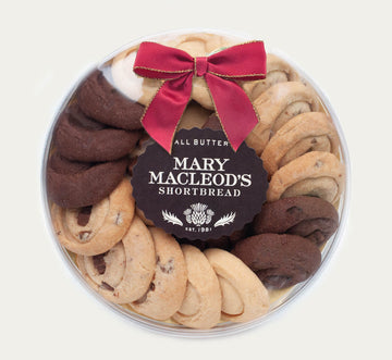 7 Inch Clear Transparent Round package of Mary Macleod's Shortbread with 21 Assorted all-butter shortbread cookies, accented with a red bow