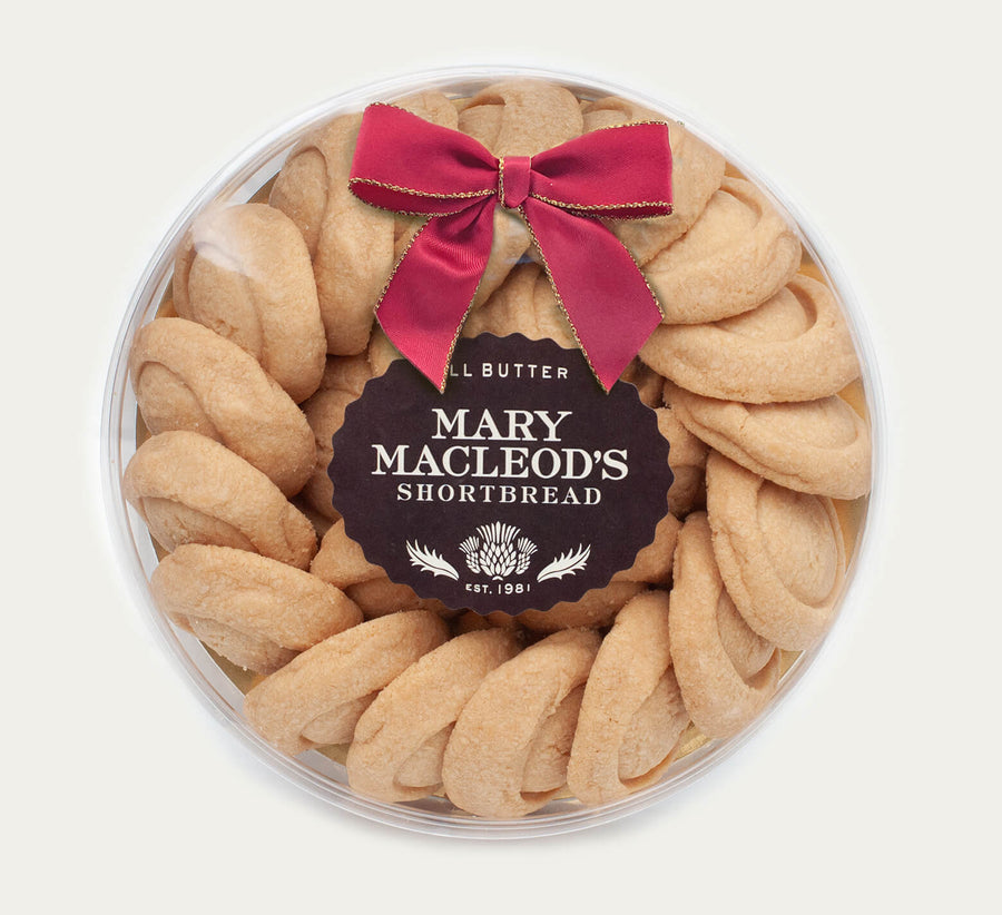 7 Inch Clear Transparent Round package of Mary Macleod's Shortbread with 21 classic all-butter shortbread cookies, accented with a red bow