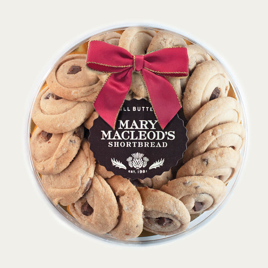 7 Inch Clear Transparent Round package of Mary Macleod's Shortbread with 21 signature chocolate crunch all-butter shortbread cookies, accented with a red bow