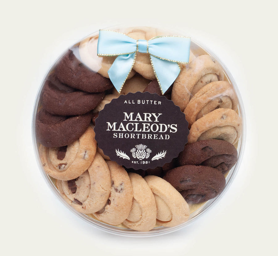 7 Inch Clear Transparent Round package of Mary Macleod's Shortbread with 21 premium artisanal gourmet signature assorted variety all-butter shortbread cookies, accented with our ocean tiffany blue bow