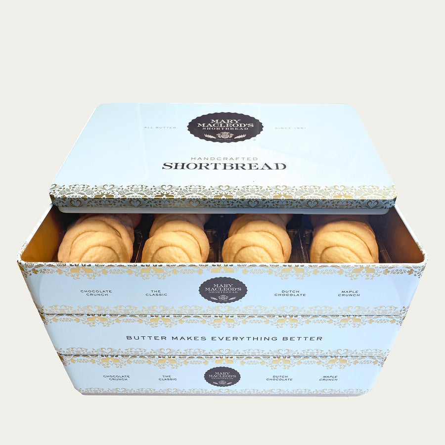 Image of Mary Macleod's Shortbread signature blue stackable cookie tin, brimming with 72 total shortbread cookies of Mary Macleod's Classic flavour. Elevate your taste experience with 72 delectable cookies crafted with rich, creamy butter. This is a three (3) layer tin. Perfect for gifting or savouring your own indulgence. Plain background. 
