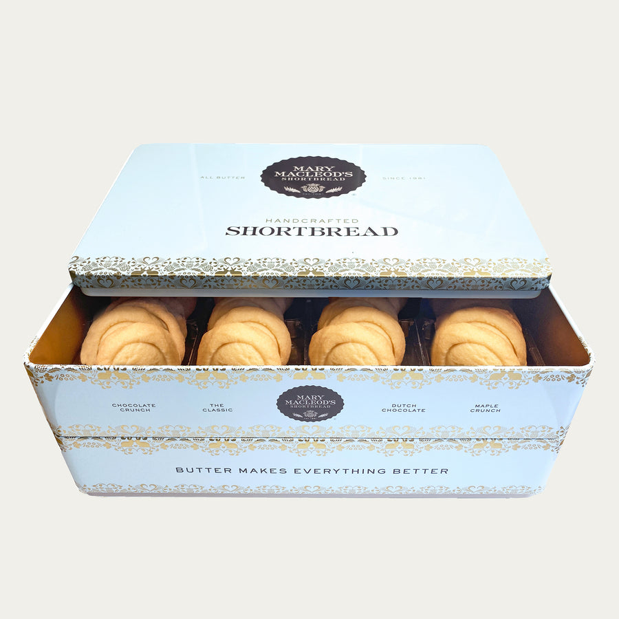 Image of Mary Macleod's Shortbread signature blue stackable cookie tin, brimming with 48 total shortbread cookies of Mary Macleod's Classic flavour. Elevate your taste experience with 48 delectable cookies crafted with rich, creamy butter. This is a two (2) layer tin. Perfect for gifting or savouring your own indulgence. Plain background. 
