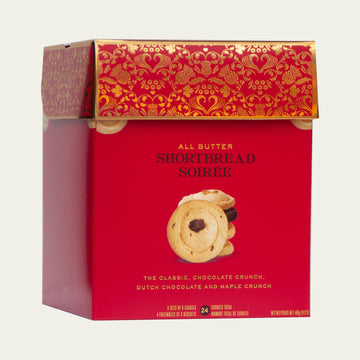 Large RED gift box of Mary Macleod's cookies, featuring a variety of delicious handmade shortbread flavors. Perfect for gifts and special occasions. Box is on an angle.